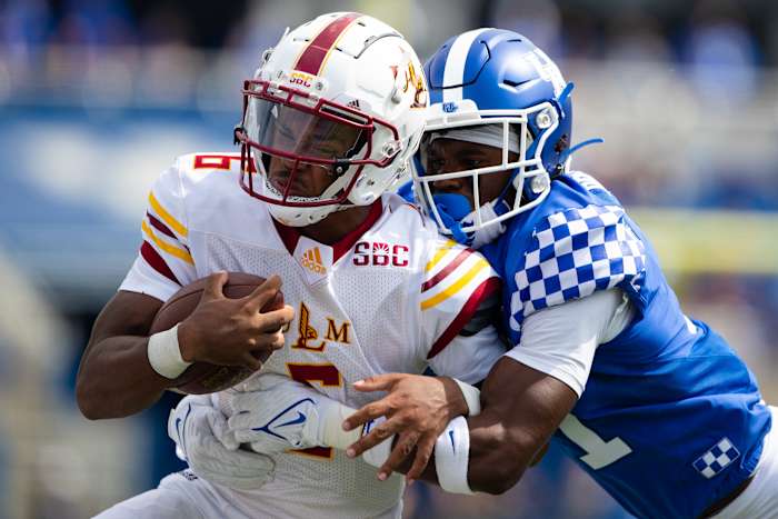 Kentucky Wildcats defensive back Moses Douglass (11) tackles Louisiana Monroe Warhawks Chandler Rogers (6) during the fourth quarter at Kroger Field.
